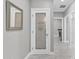 Hallway view of a pantry with a frosted glass door and adjacent laundry area at 21575 E Twin Acres Ct, Queen Creek, AZ 85142
