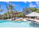 Resort-style pool featuring palm trees, waterfall, spa and ample space for entertaining in this desert oasis at 21575 E Twin Acres Ct, Queen Creek, AZ 85142