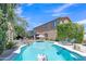Backyard pool with tropical foliage and lounge seating at 21575 E Twin Acres Ct, Queen Creek, AZ 85142