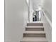 Carpeted stairs lead to an upper floor and rooms with neutral walls and white trim at 21575 E Twin Acres Ct, Queen Creek, AZ 85142