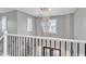 Staircase with crystal light fixture, white railings and shuttered windows at 21575 E Twin Acres Ct, Queen Creek, AZ 85142