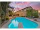 Expansive backyard with a refreshing pool and ample seating, ideal for outdoor gatherings and enjoying the beautiful sunset at 21575 E Twin Acres Ct, Queen Creek, AZ 85142