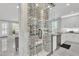 Elegant wine cellar next to a modern kitchen, featuring marble accents and glass enclosure at 21575 E Twin Acres Ct, Queen Creek, AZ 85142