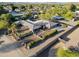 Aerial view of a sprawling home with lush greenery, palm trees, and a secure gated entrance at 22039 N 86Th Ave, Peoria, AZ 85383