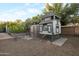 Charming backyard featuring a custom chicken coop, a flourishing garden, and a gravel-covered area at 22039 N 86Th Ave, Peoria, AZ 85383
