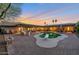 Rear view of a backyard featuring a diving board on a pool, surrounded by patio and landscaping at 22039 N 86Th Ave, Peoria, AZ 85383