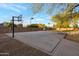 Full-sized concrete basketball court, complete with hoops and perimeter lighting at 22039 N 86Th Ave, Peoria, AZ 85383