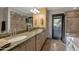 Bathroom with dual vanity, a granite countertop, a soaking tub and a separate shower at 22039 N 86Th Ave, Peoria, AZ 85383