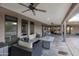Expansive covered patio featuring lounge furniture, ceiling fans, and a view of the backyard, perfect for entertaining at 22039 N 86Th Ave, Peoria, AZ 85383