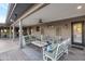 Spacious covered patio furnished with comfortable seating, ceiling fans, and a welcoming atmosphere for outdoor enjoyment at 22039 N 86Th Ave, Peoria, AZ 85383