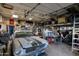 Organized garage space with classic car, shelving, storage and work area at 22039 N 86Th Ave, Peoria, AZ 85383
