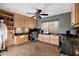 Home office with abundant counterspace, a ceiling fan, and a mounted shelving unit at 22039 N 86Th Ave, Peoria, AZ 85383