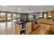 The kitchen features a large island with black granite countertops, neutral walls, stainless steel appliances, and tile flooring at 22039 N 86Th Ave, Peoria, AZ 85383
