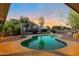 Beautiful kidney-shaped pool with clear water, a diving board, and adjacent landscaping at 22039 N 86Th Ave, Peoria, AZ 85383