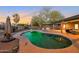 Inviting pool area with lush landscaping, ample seating, and a picturesque sunset view, ideal for relaxation and recreation at 22039 N 86Th Ave, Peoria, AZ 85383