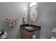 Charming powder room with vanity and granite countertop at 22039 N 86Th Ave, Peoria, AZ 85383