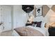 Stylishly decorated bedroom featuring neutral colors, a large light fixture and elegant accents at 24643 N 164Th Dr, Surprise, AZ 85387