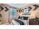 Charming bedroom with airplane themed wall decor, side tables, and a striped comforter at 24643 N 164Th Dr, Surprise, AZ 85387