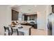 Stylish kitchen with stainless appliances, gray cabinetry, and a breakfast bar area at 24643 N 164Th Dr, Surprise, AZ 85387