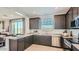 Modern kitchen with stainless steel appliances, ample counter space, and a view of the backyard at 24643 N 164Th Dr, Surprise, AZ 85387
