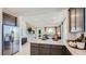 Open-concept kitchen featuring stainless steel appliances and a breakfast bar at 24643 N 164Th Dr, Surprise, AZ 85387