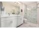 Bright bathroom featuring double sink vanity and modern glass-enclosed shower with stylish tiling at 2511 W Queen Creek Rd # 258, Chandler, AZ 85248