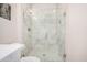 Close-up of the luxurious marble shower with glass door and built-in bench in the bathroom at 2511 W Queen Creek Rd # 258, Chandler, AZ 85248