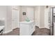 Kitchen island with white cabinets and light countertop adjacent to 3 entry doors at 2511 W Queen Creek Rd # 258, Chandler, AZ 85248