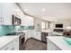 Bright kitchen with stainless appliances, white cabinets, granite countertops, and decorative tile backsplash at 2511 W Queen Creek Rd # 258, Chandler, AZ 85248