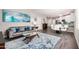 Open-concept living space boasts a stylish sofa, eye-catching artwork, and seamless flow to dining area at 2511 W Queen Creek Rd # 258, Chandler, AZ 85248