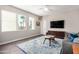Cozy living room features ample natural light, stylish rug, and modern decor for comfortable living at 2511 W Queen Creek Rd # 258, Chandler, AZ 85248