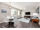 Well-lit dining and living area features a sleek table set and a stylish rug under a modern coffee table at 2511 W Queen Creek Rd # 258, Chandler, AZ 85248