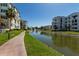 View of the pond with fountain between two condominium buildings along a walkway at 2511 W Queen Creek Rd # 258, Chandler, AZ 85248