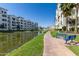 Pond view between condominium buildings on a sunny day with a blue bench at 2511 W Queen Creek Rd # 258, Chandler, AZ 85248