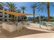 Poolside covered bar featuring modern stools and views of the pool and palms at 2511 W Queen Creek Rd # 258, Chandler, AZ 85248