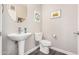 Clean powder room featuring a unique vessel sink, round mirror, and modern fixtures at 2511 W Queen Creek Rd # 258, Chandler, AZ 85248