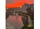 Stunning waterfront view with buildings and vivid sunset colors reflected in the water at 2511 W Queen Creek Rd # 258, Chandler, AZ 85248