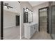 Bathroom showcasing the vanity, walk-in closet, and glass enclosed shower at 25846 W Denver Hill Dr, Wittmann, AZ 85361