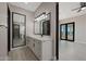 Elegant bathroom featuring a double vanity, large mirrors, and modern fixtures at 25846 W Denver Hill Dr, Wittmann, AZ 85361