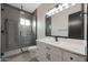 Modern bathroom with glass-enclosed shower and white vanity with white countertop at 25846 W Denver Hill Dr, Wittmann, AZ 85361