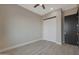 Bedroom with light-colored walls, modern barn door, and wood-look tile flooring at 25846 W Denver Hill Dr, Wittmann, AZ 85361