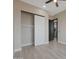Neutral bedroom features a ceiling fan, wood-look floors and closet with sliding doors at 25846 W Denver Hill Dr, Wittmann, AZ 85361
