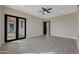 Spacious bedroom featuring wood-look tile flooring and a ceiling fan at 25846 W Denver Hill Dr, Wittmann, AZ 85361