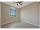 Bedroom featuring a ceiling fan and a large window offering an open view at 25846 W Denver Hill Dr, Wittmann, AZ 85361