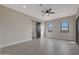 Spacious bedroom features wood-look tile flooring, barn door, and bright windows at 25846 W Denver Hill Dr, Wittmann, AZ 85361