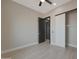Bedroom with light-colored walls, modern barn door, and wood-look tile flooring at 25846 W Denver Hill Dr, Wittmann, AZ 85361