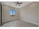 Bright bedroom with ceiling fan, recessed lighting, wood-look floors, and large window at 25846 W Denver Hill Dr, Wittmann, AZ 85361