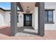 Inviting front entrance with a modern door, decorative lighting, and clean, contemporary design elements at 25846 W Denver Hill Dr, Wittmann, AZ 85361