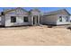 A newly built home, captured pre-landscaping, showcasing its modern design under construction at 25846 W Denver Hill Dr, Wittmann, AZ 85361