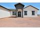Charming home exterior featuring a covered entrance with modern lighting and minimalist landscaping at 25846 W Denver Hill Dr, Wittmann, AZ 85361